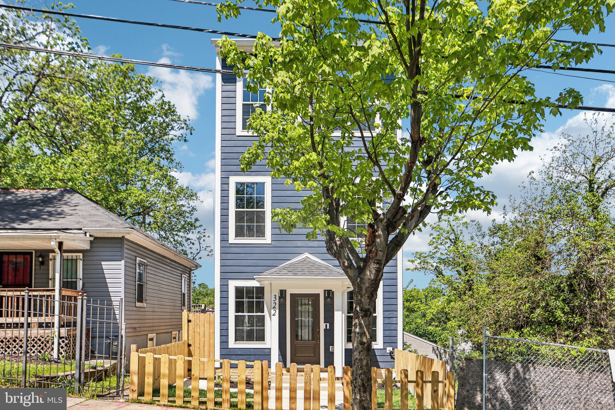 322 56th Street Northeast Washington, DC 20019 - Photo 6 of 57 a front view of a house with a garden
