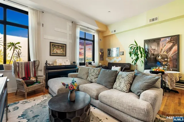 a living room with furniture a dining table and a piano
