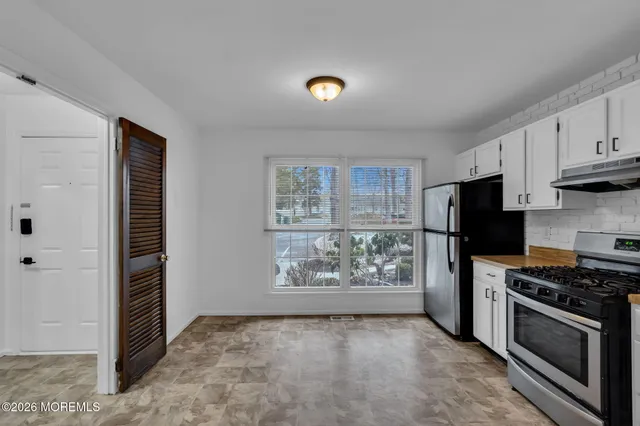 a view of a kitchen with an empty space and a window