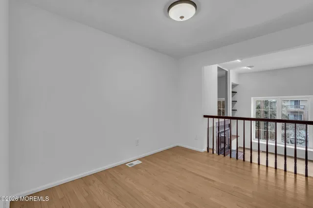 a view of hallway with wooden floor