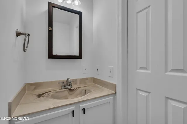 a bathroom with a sink and a mirror