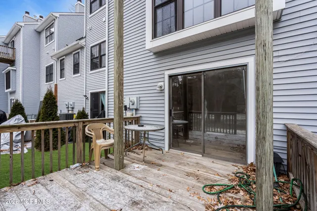 a view of a deck with table and chairs with wooden floor and fence