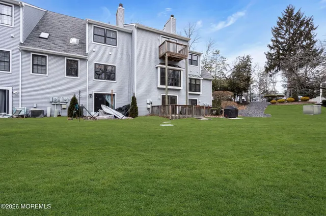 a front view of a house with a garden and trees
