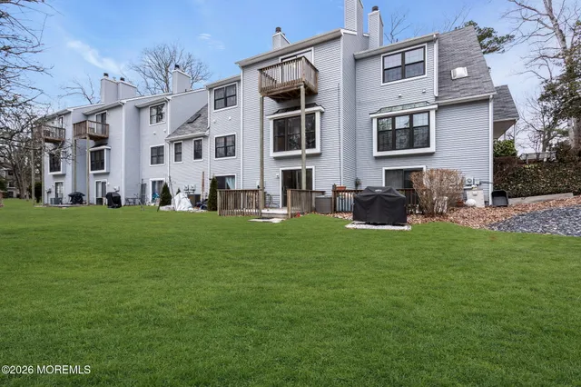 a front view of building with yard and outdoor seating