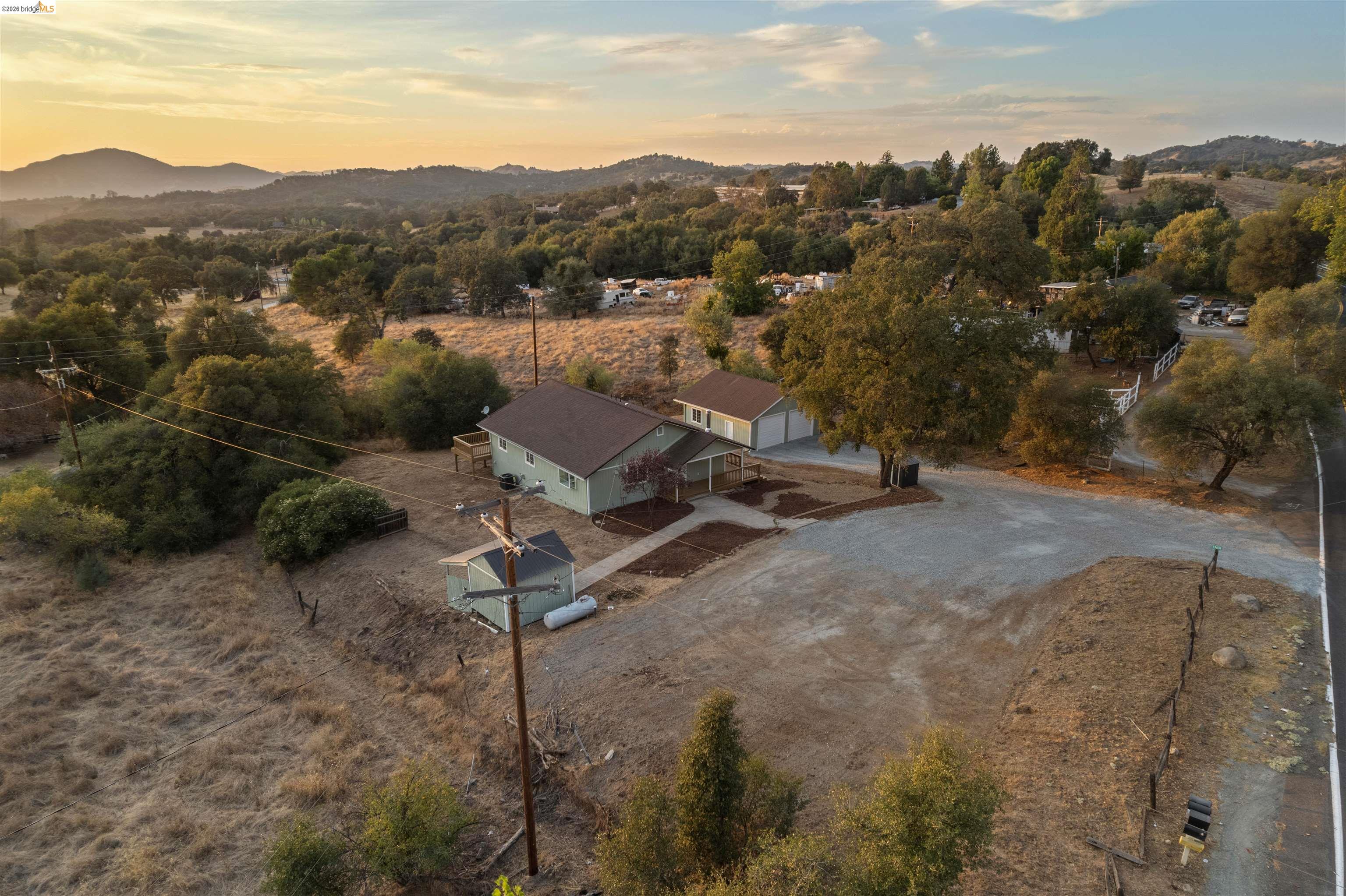 19676 Rawhide Road Sonora, CA 95370 - Photo 67 of 67 Single-story residence with a pitched roof, a detached two-car garage, and a separate outbuilding