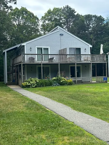 a front view of a house with a garden and porch