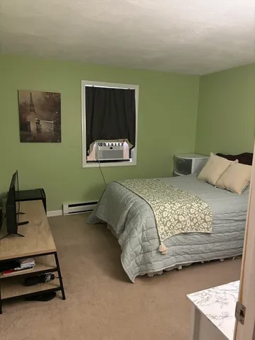 a bedroom with a bed and a desk