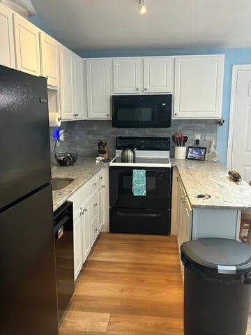 a kitchen with a sink a stove and refrigerator