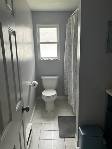 a white toilet sitting next to a bathroom sink