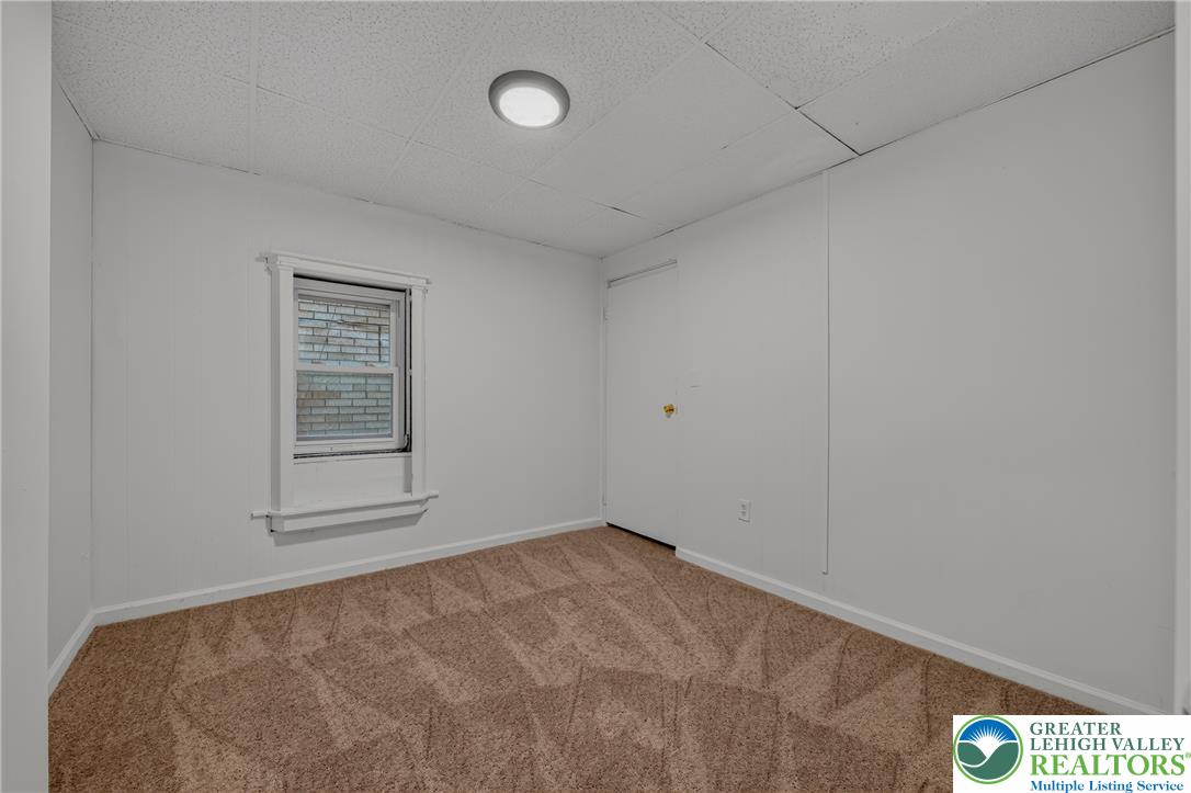 313 Main Street Slatington, PA 18080 - Photo 21 of 73 A cozy bedroom features carpeted flooring and a window offering natural illumination.