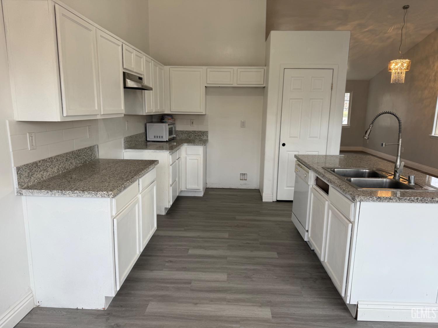 Undisclosed Address Bakersfield, CA 93313 - Photo 24 of 37 a kitchen with sink a stove and cabinets