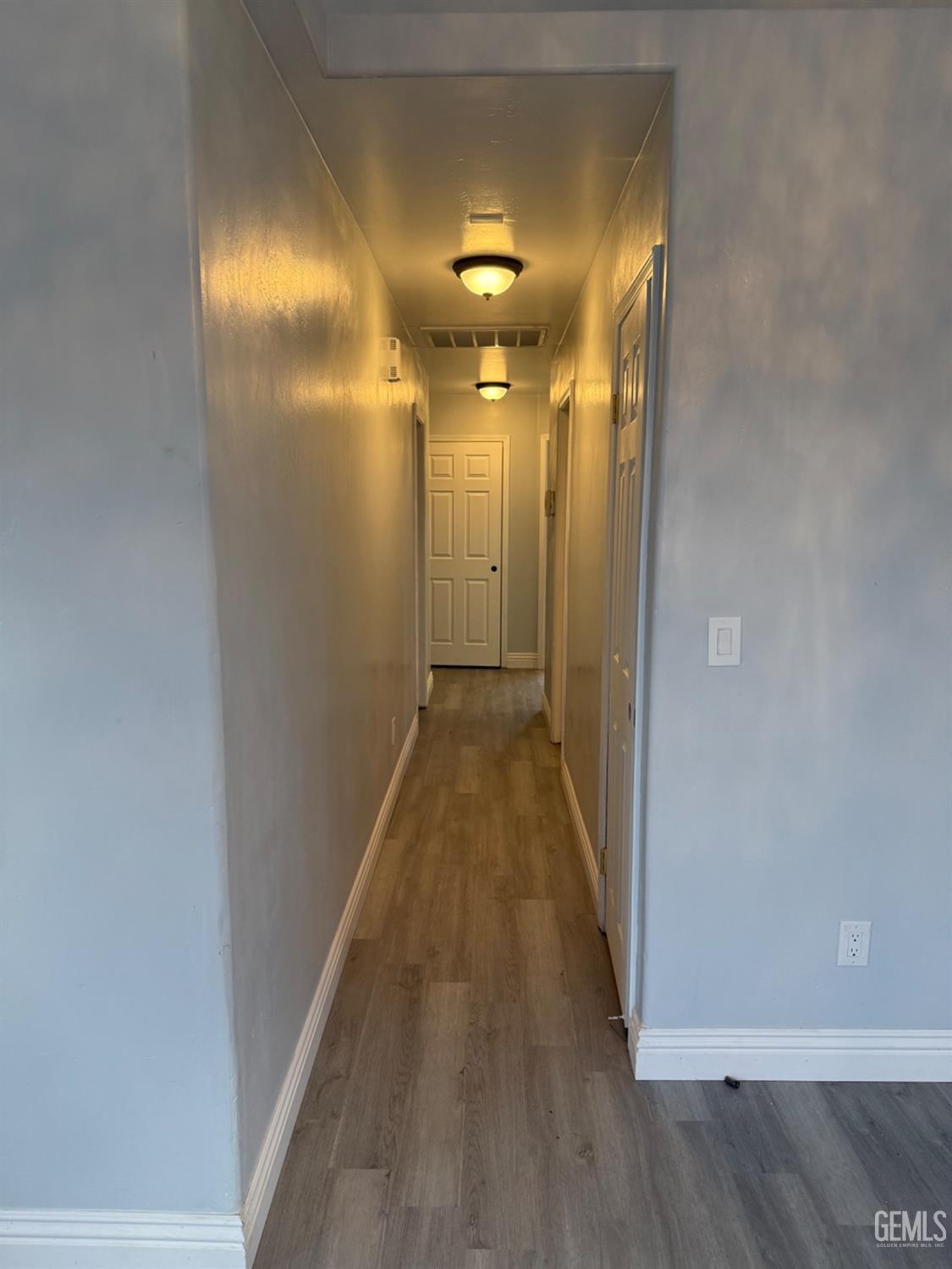 Undisclosed Address Bakersfield, CA 93313 - Photo 28 of 37 a view of a hallway with wooden floor