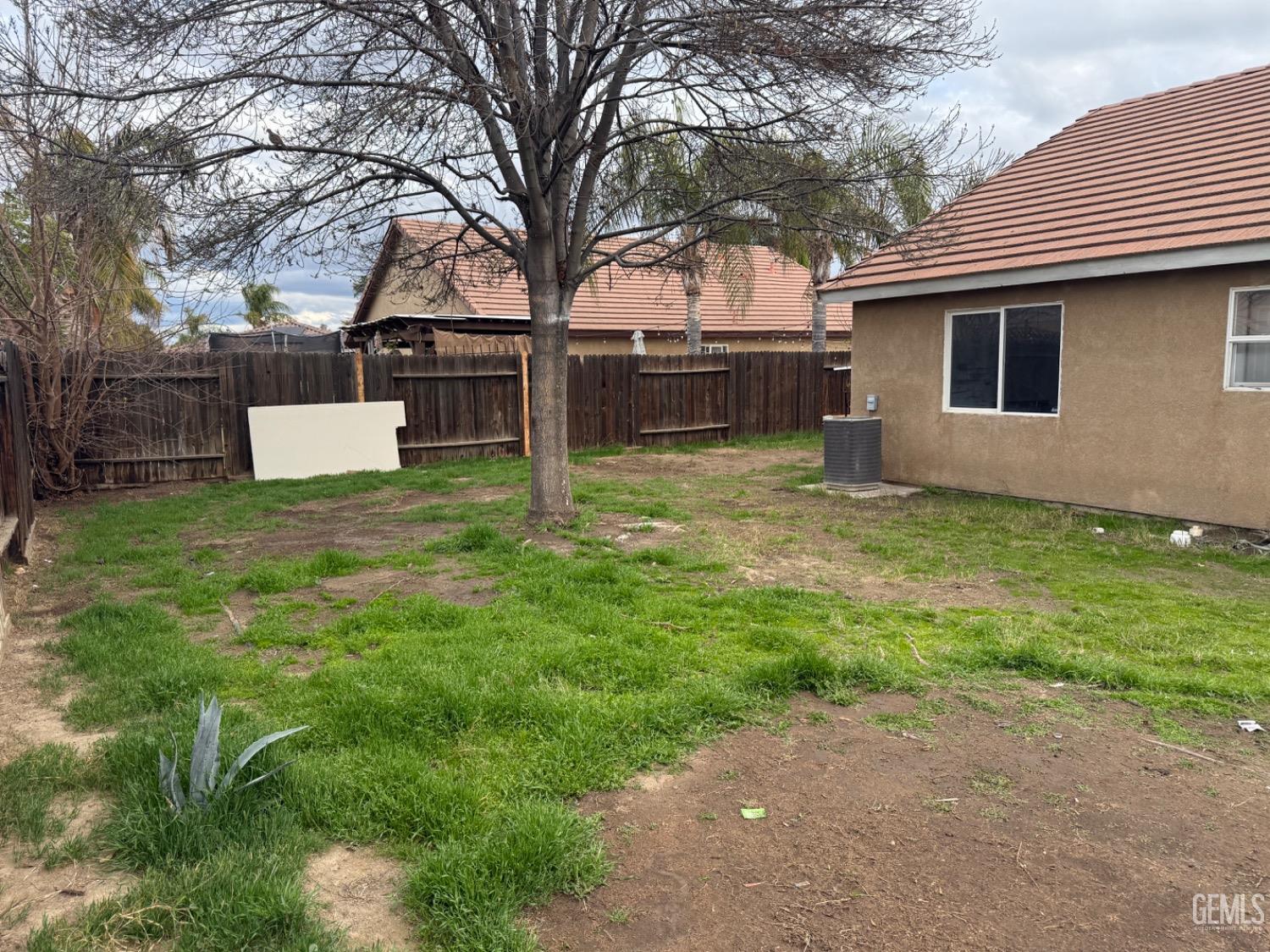 Undisclosed Address Bakersfield, CA 93313 - Photo 35 of 37 a view of a backyard with a white house