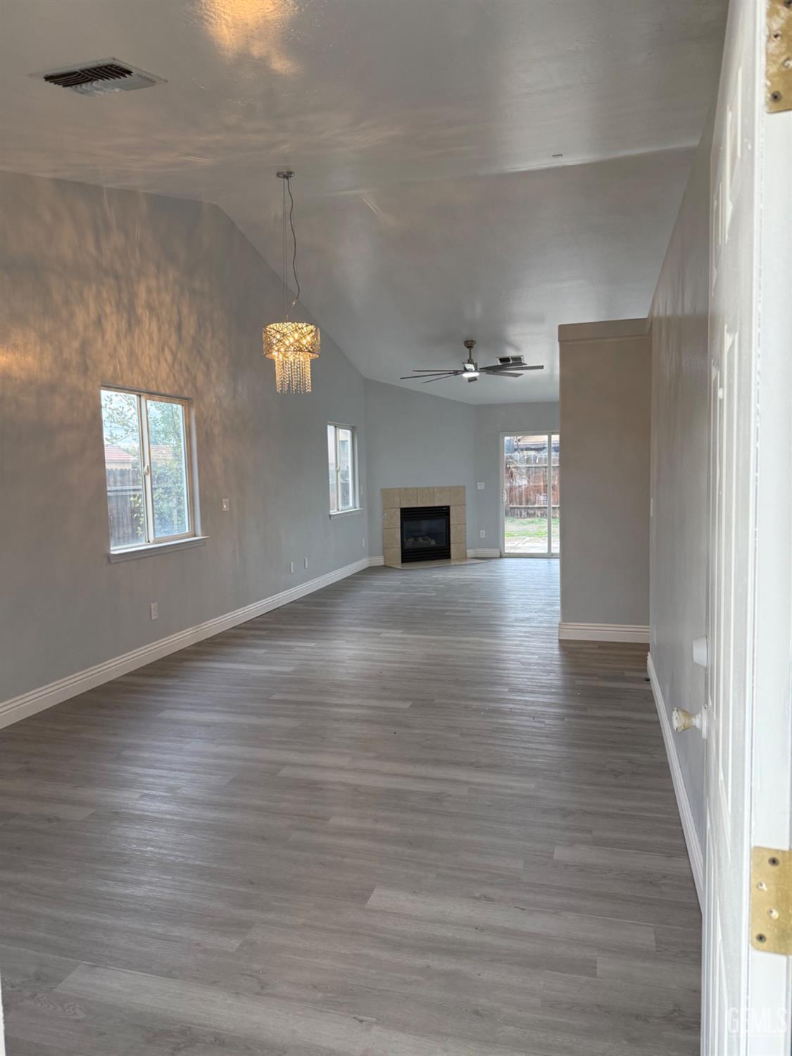 Undisclosed Address Bakersfield, CA 93313 - Photo 5 of 37 a view of empty room with window and wooden floor
