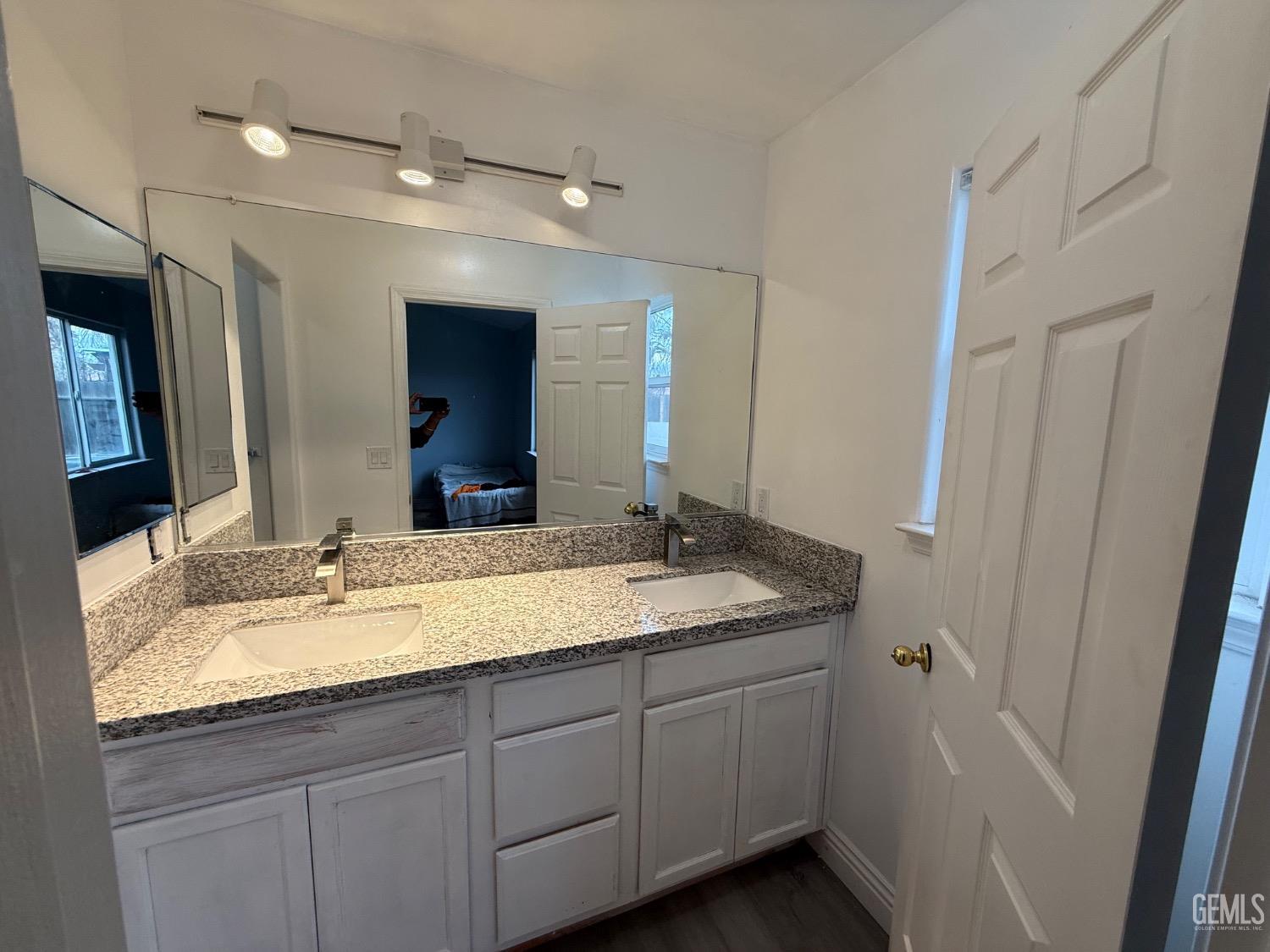 Undisclosed Address Bakersfield, CA 93313 - Photo 8 of 37 a bathroom with a granite countertop sink double and mirror