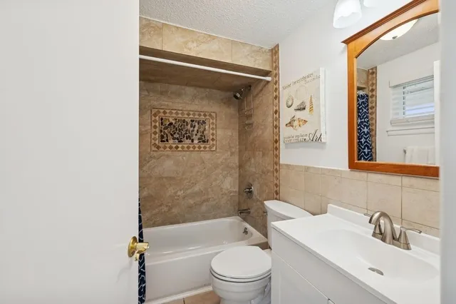 a spacious bedroom with a bed and a window