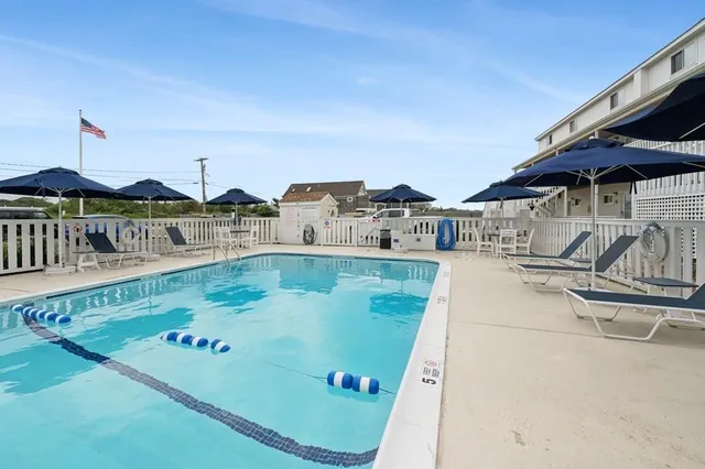 swimming pool view with a seating space