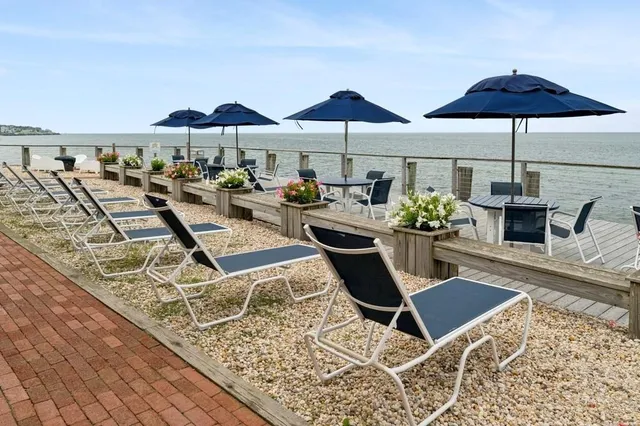 a view of a patio with chairs under an umbrella
