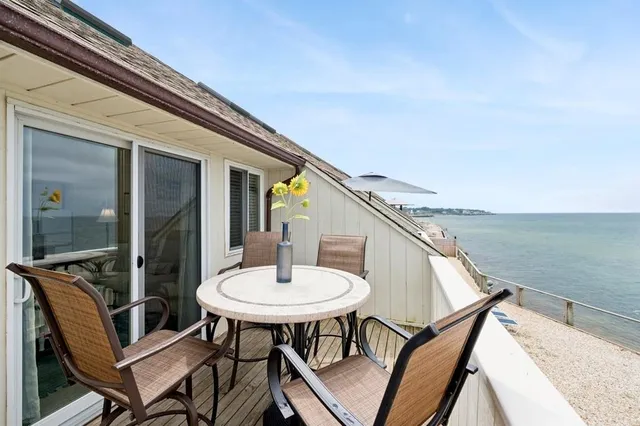 a balcony with table and chairs