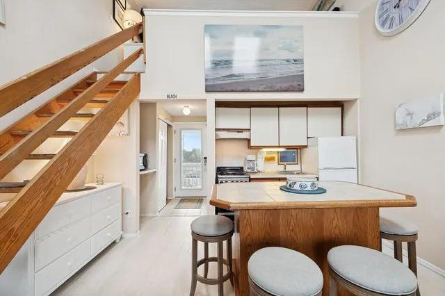 a dining room with furniture and a floor to ceiling window