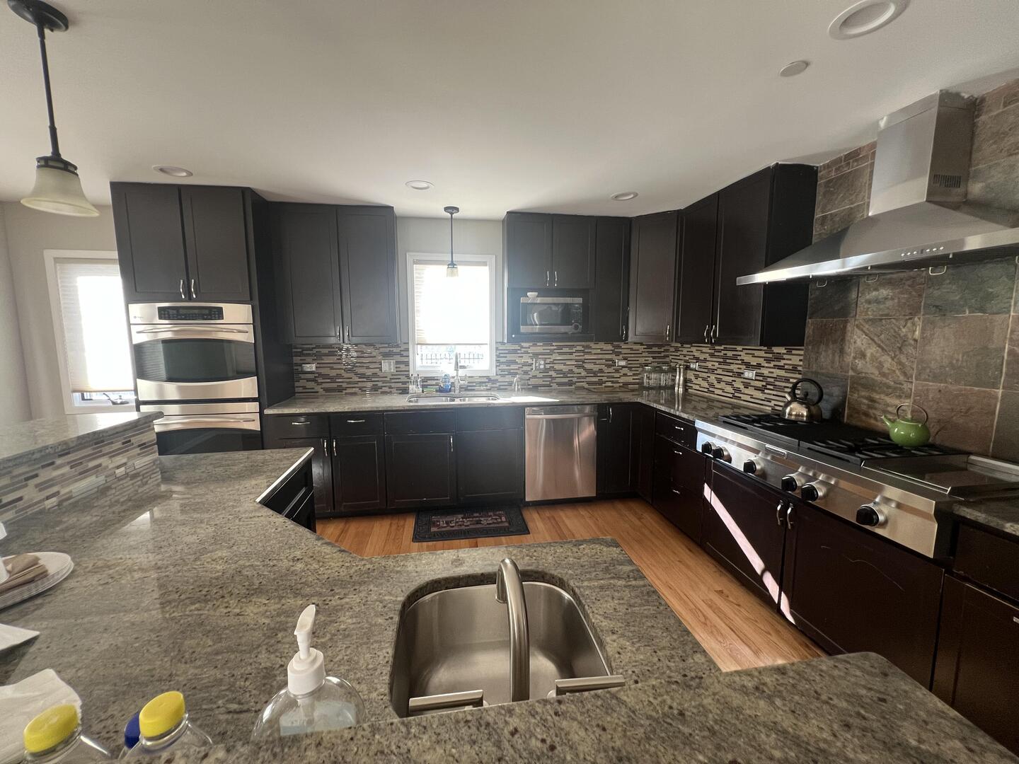 4429 203rd Street Matteson, IL 60443 - Photo 11 of 29 a kitchen with stainless steel appliances granite countertop a sink a stove top oven a counter space and cabinets
