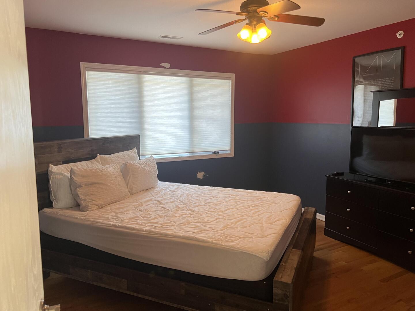 4429 203rd Street Matteson, IL 60443 - Photo 13 of 29 a bedroom with a bed and a chandelier