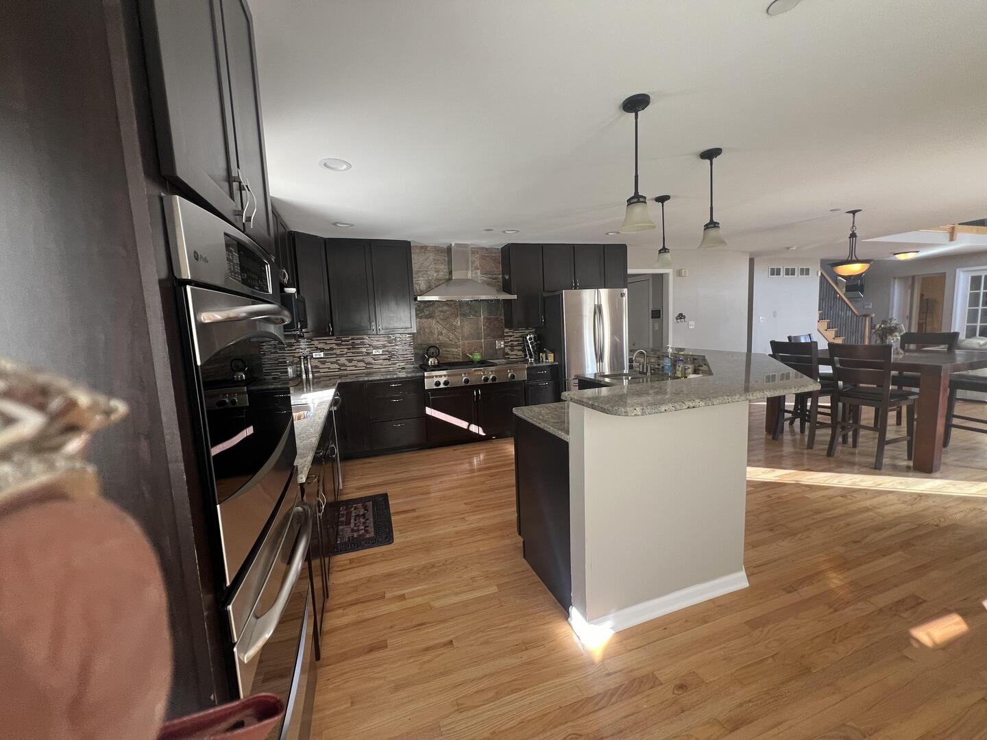 4429 203rd Street Matteson, IL 60443 - Photo 10 of 29 a living room with stainless steel appliances kitchen island granite countertop a table chairs and a refrigerator