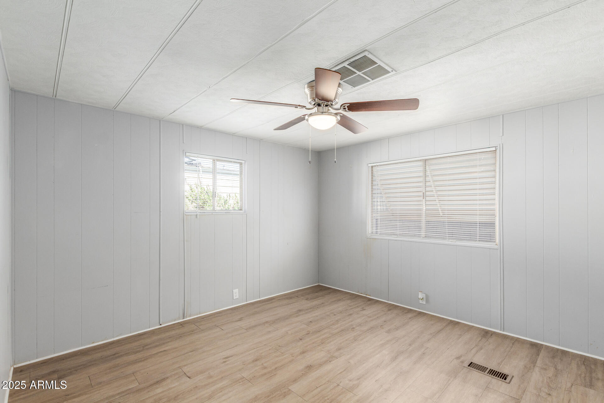16225 North Cave Creek Road, Unit 140 Phoenix, AZ 85032 - Photo 16 of 32 an empty room with windows and fan