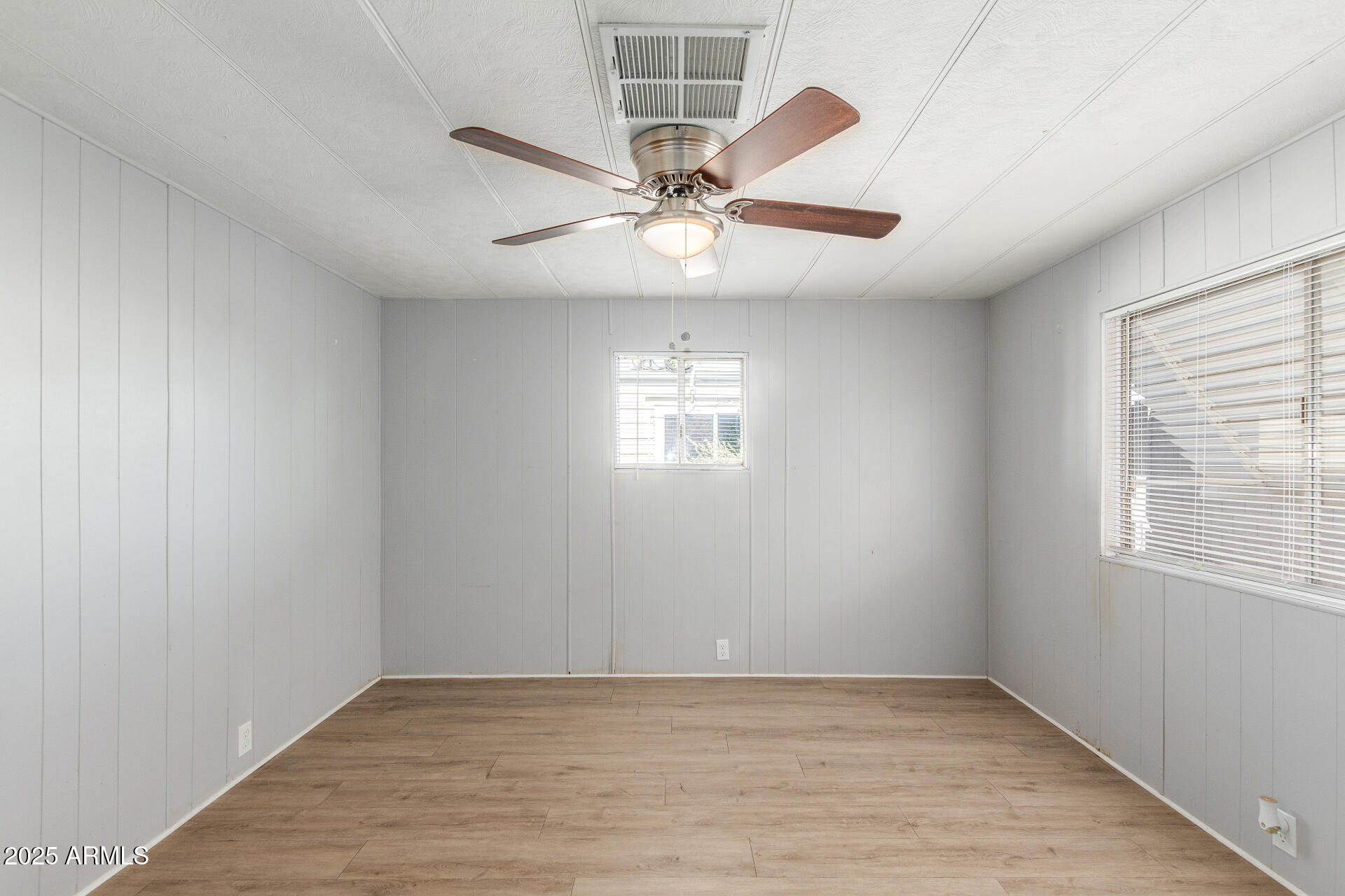 16225 North Cave Creek Road, Unit 140 Phoenix, AZ 85032 - Photo 17 of 32 an empty room with windows and fan