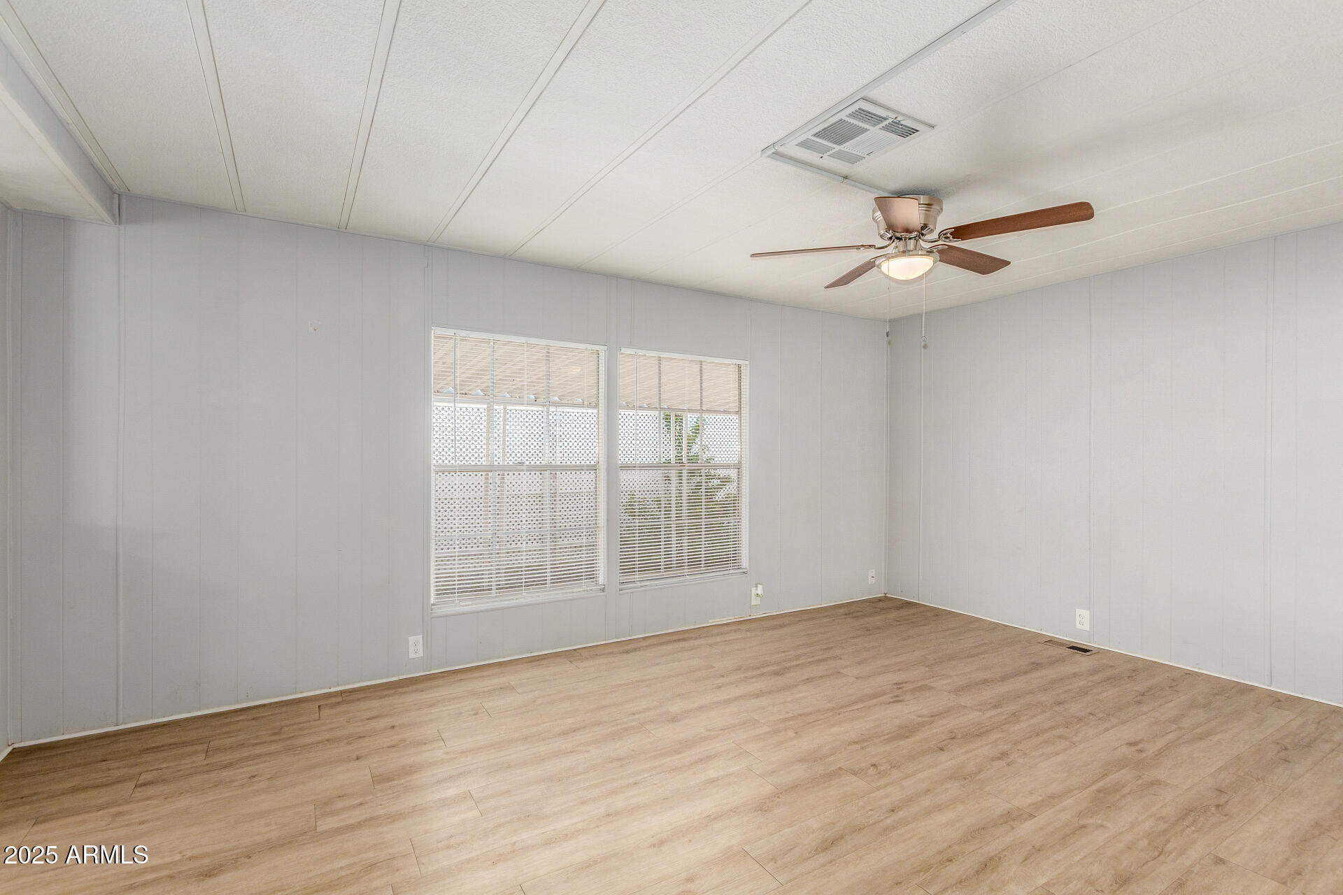 16225 North Cave Creek Road, Unit 140 Phoenix, AZ 85032 - Photo 9 of 32 wooden floor in an empty room with a window