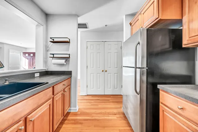 a kitchen with stainless steel appliances granite countertop a refrigerator and a sink