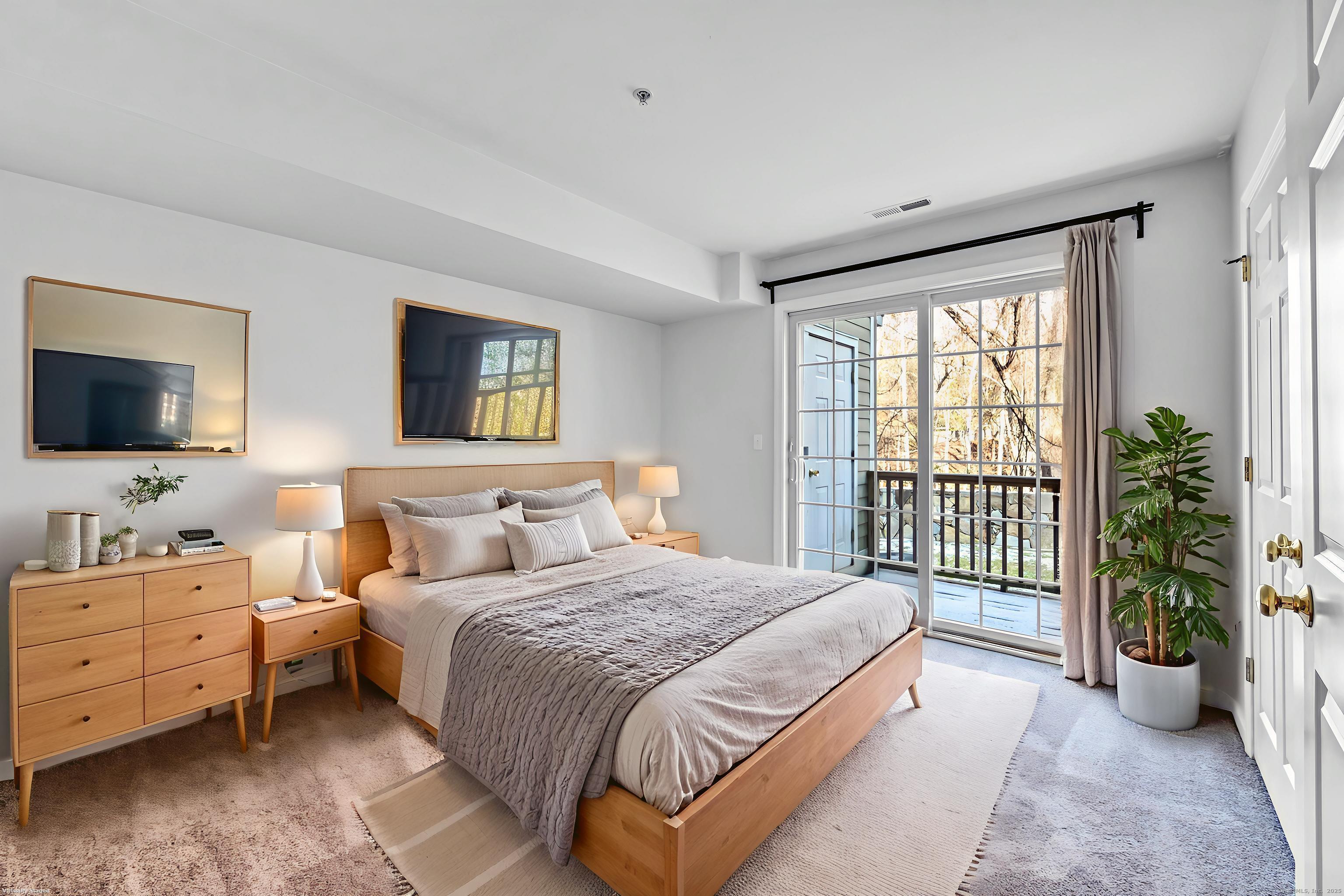 793 Federal Road, Unit 3 Brookfield, CT 06804 - Photo 20 of 30 a bedroom with a balcony a bed and a flat screen television