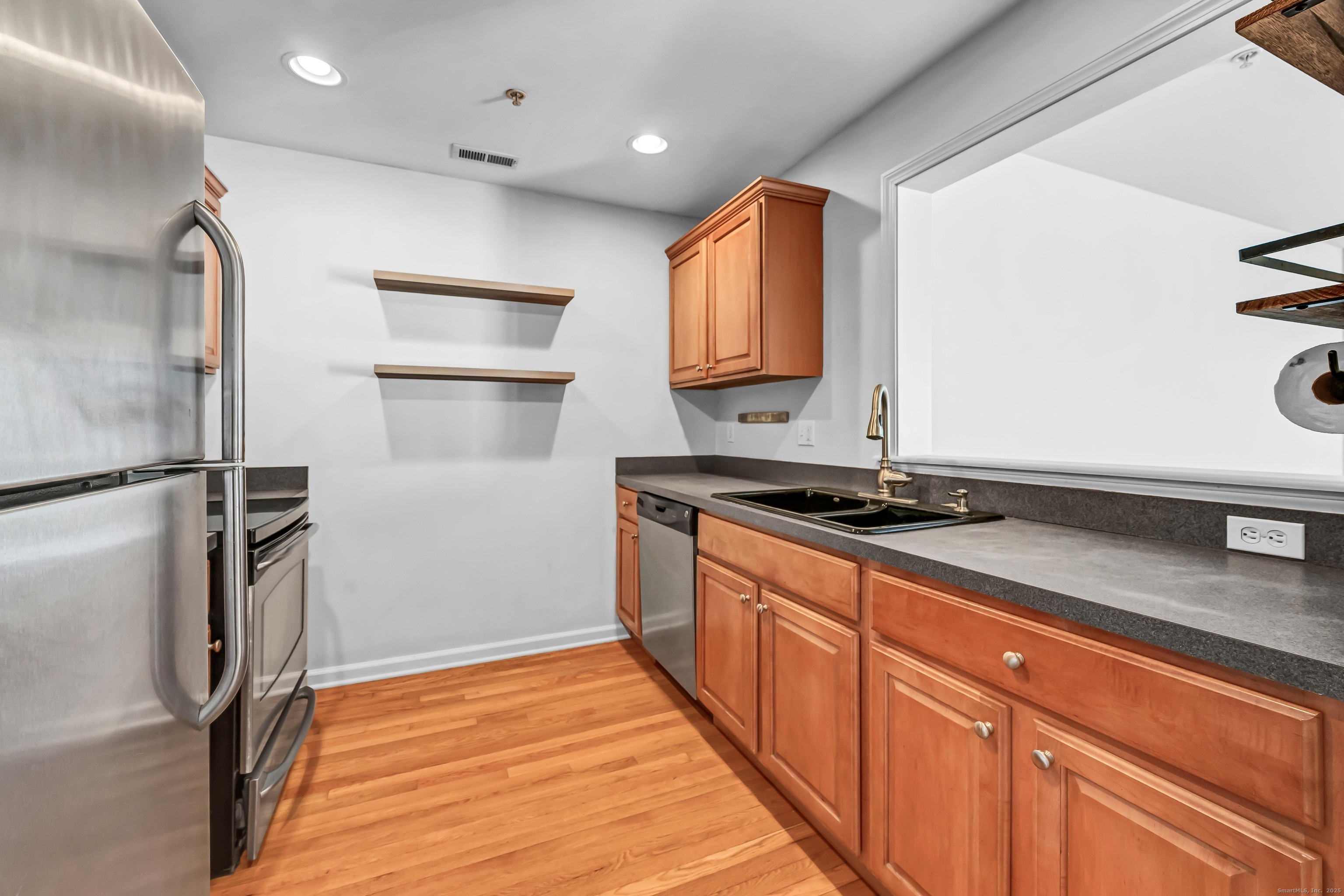 793 Federal Road, Unit 3 Brookfield, CT 06804 - Photo 9 of 30 a kitchen with stainless steel appliances granite countertop a refrigerator and a sink