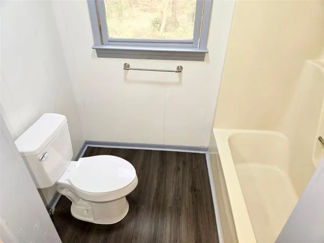 a toilet sitting in a bathroom next to a sink