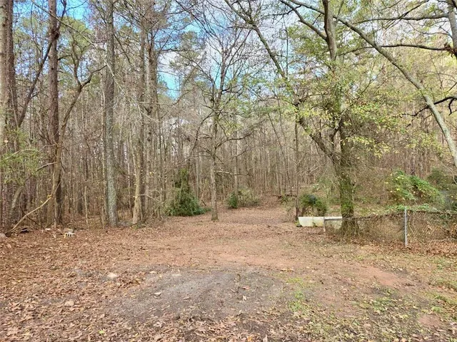 a backyard of a house with lots of trees