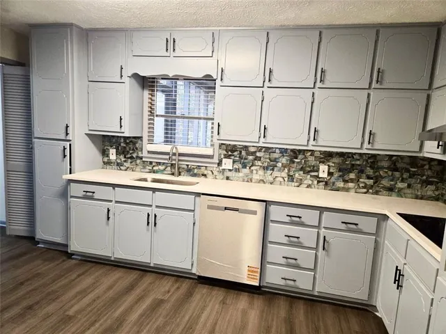 a kitchen with stainless steel appliances granite countertop a sink stove and cabinets