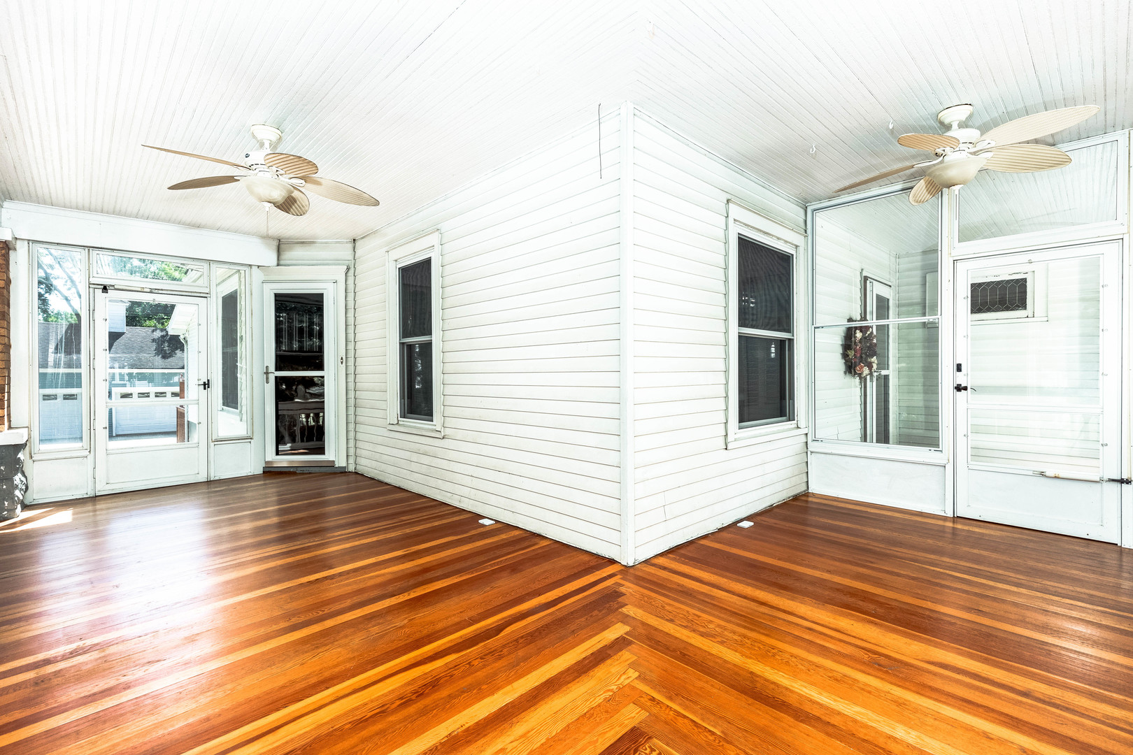 809 Ottawa Avenue Ottawa, IL 61350 - Photo 3 of 39 a view of a livingroom with wooden floor and ceiling fan