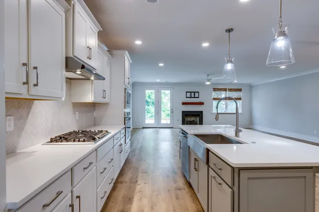 an empty room with wooden floor and window