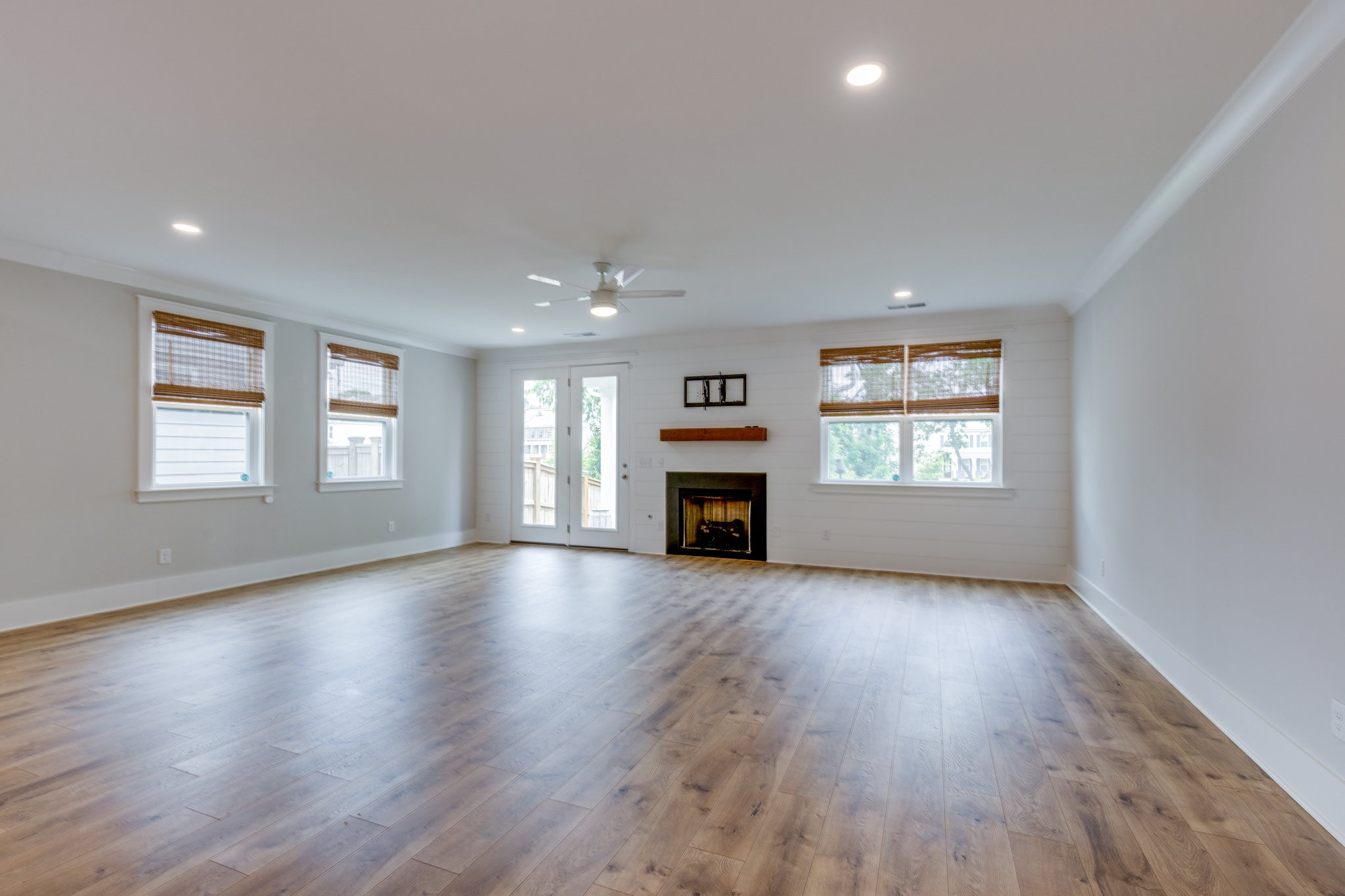2110 Lequire Lane Spring Hill, TN 37174 - Photo 18 of 76 an empty room with wooden floor fireplace and windows