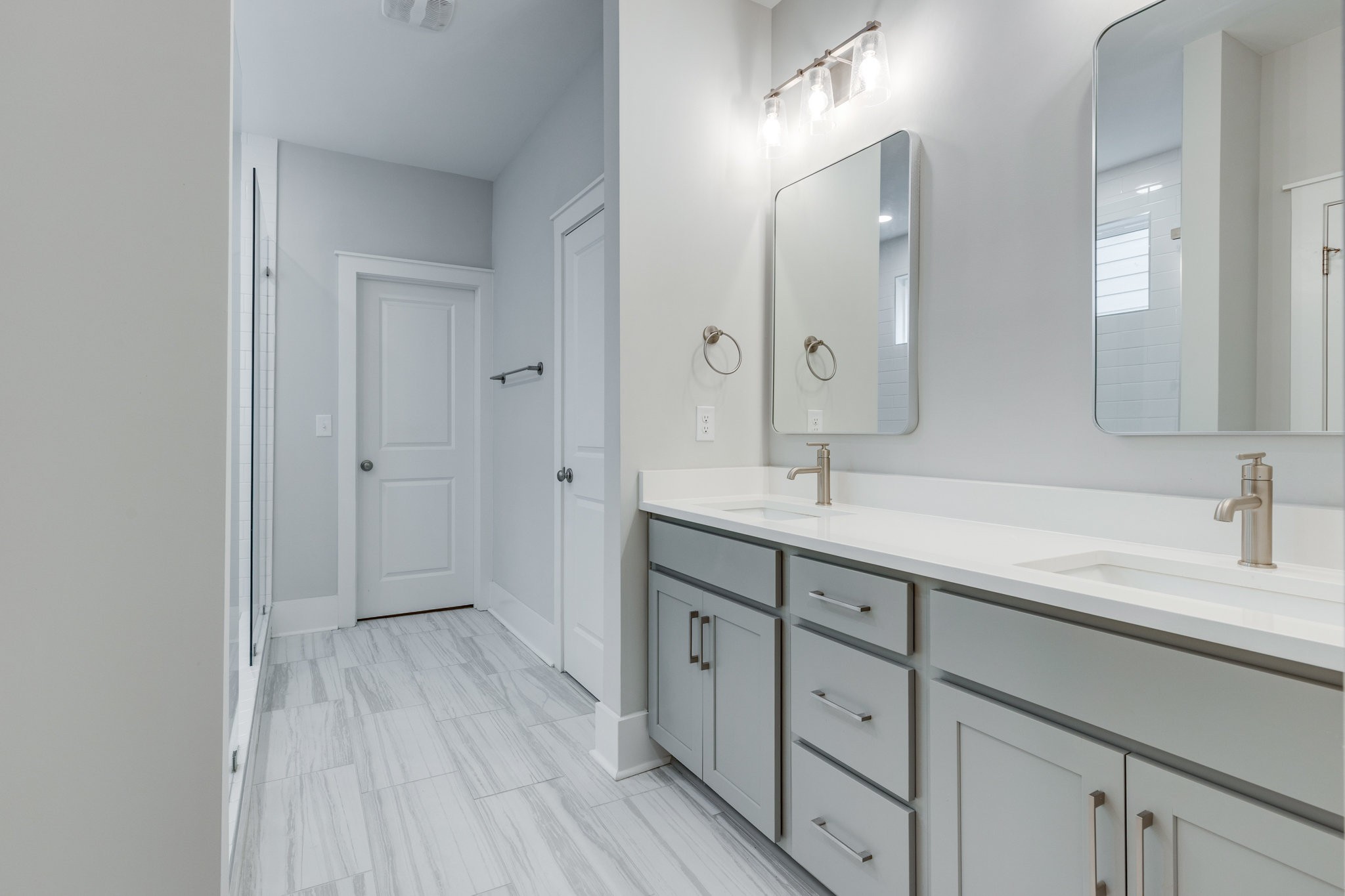 2110 Lequire Lane Spring Hill, TN 37174 - Photo 29 of 76 a spacious bathroom with a double vanity sink and mirror