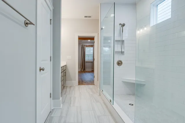 an aerial view of green field with trees