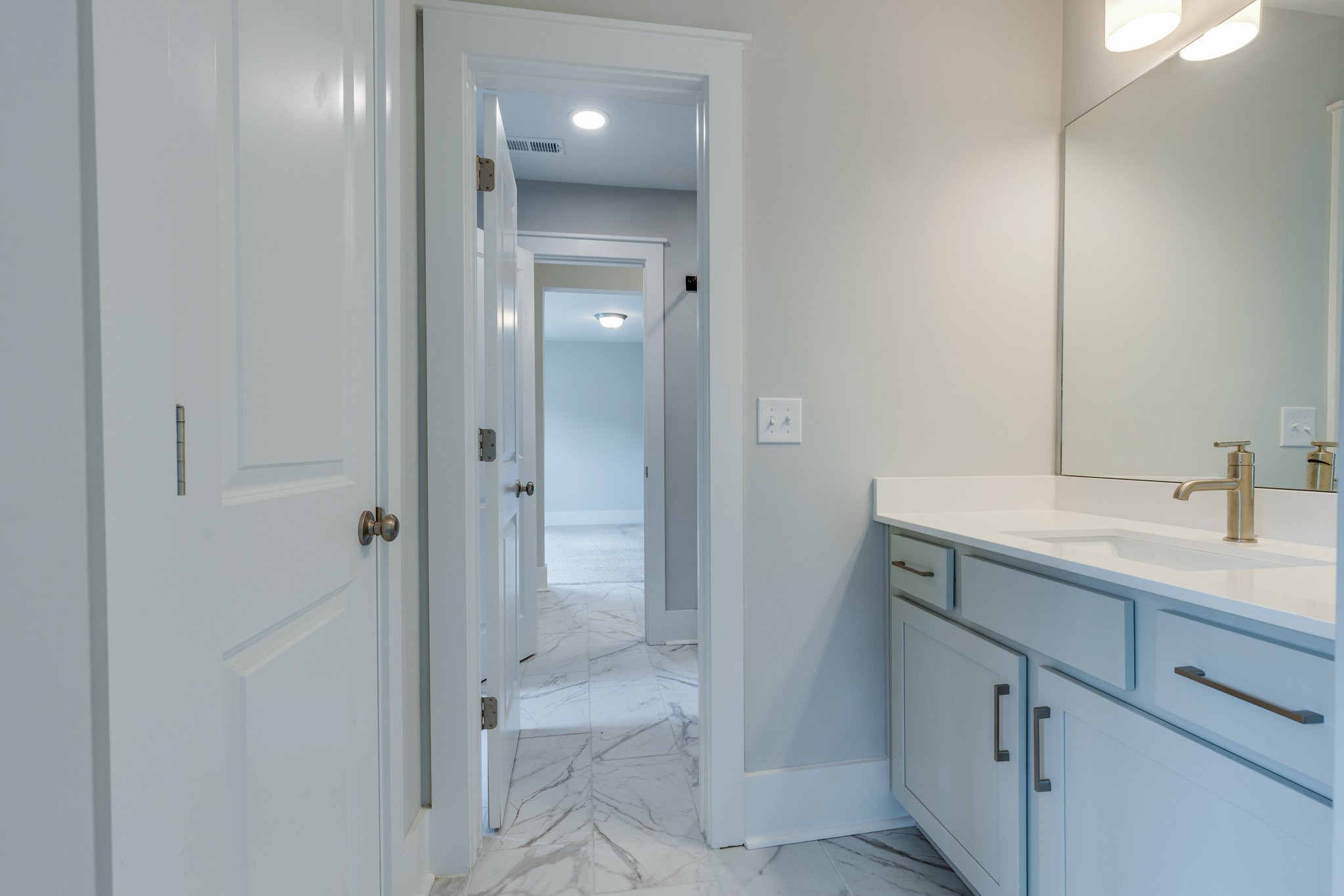 2110 Lequire Lane Spring Hill, TN 37174 - Photo 39 of 76 a bathroom with a shower sink and mirror