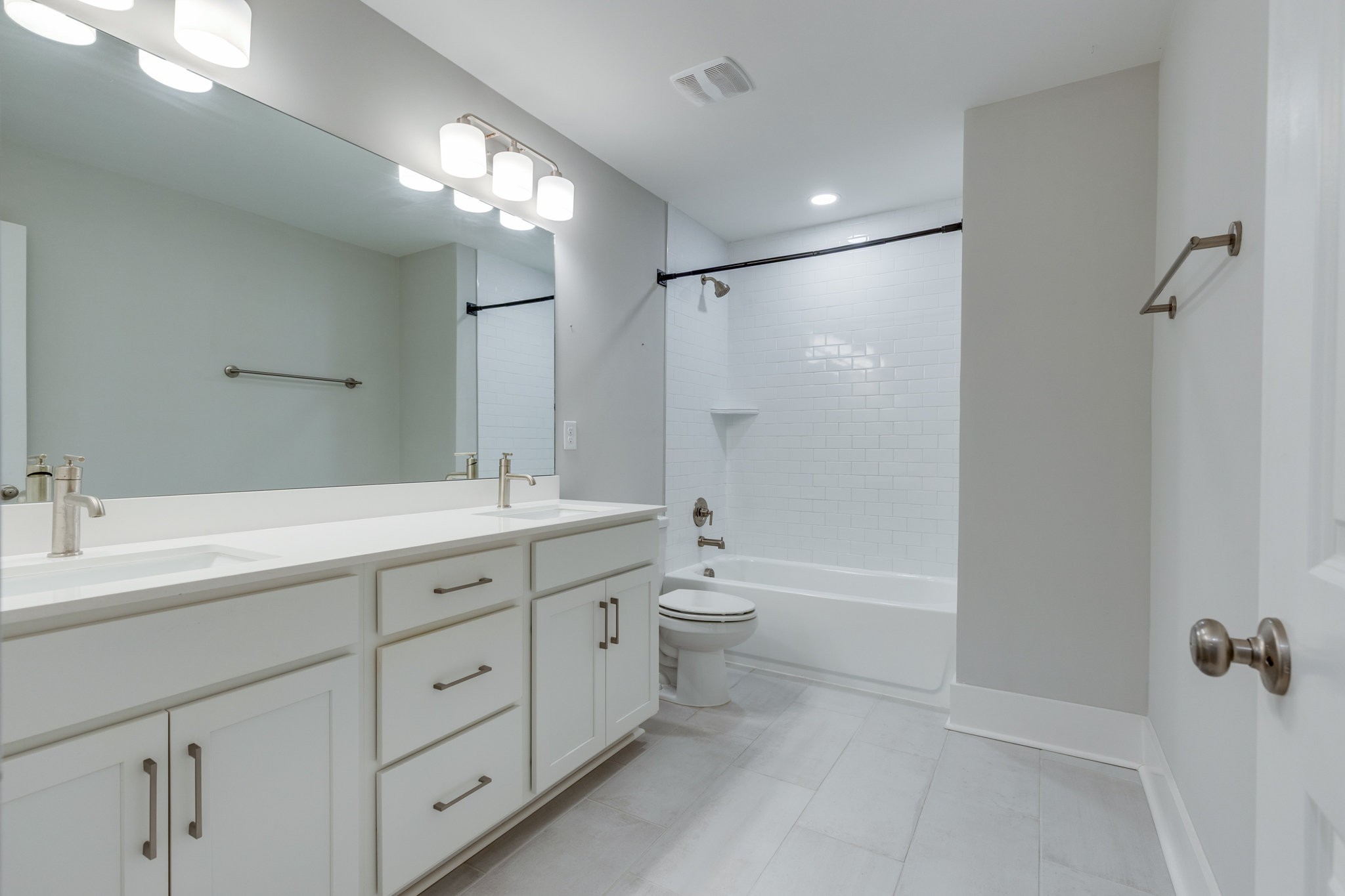2110 Lequire Lane Spring Hill, TN 37174 - Photo 45 of 76 a spacious bathroom with a double vanity sink toilet mirror and bathtub
