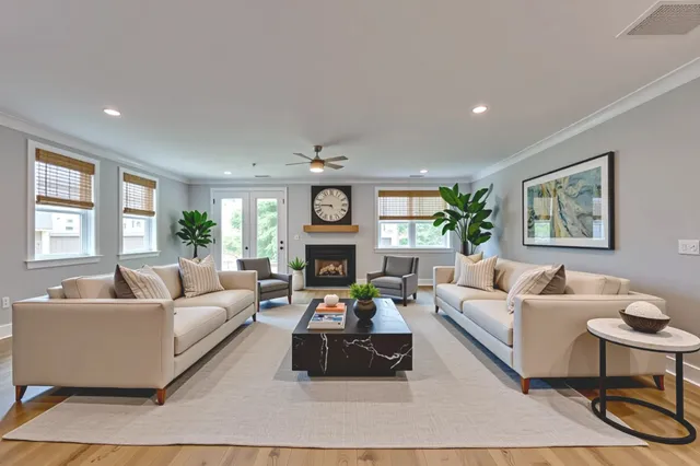 a kitchen with kitchen island a stove a sink a refrigerator and cabinets