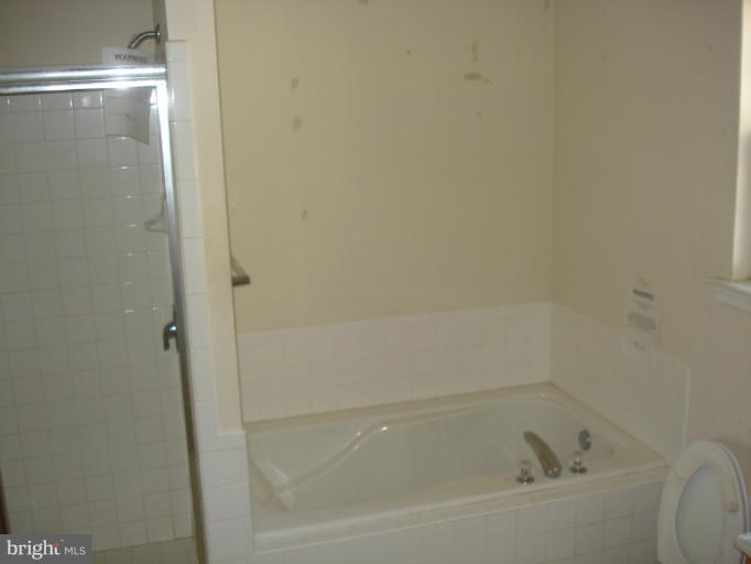 570 Balsom Road Lusby, MD 20657 - Photo 12 of 16 a bathroom with a bathtub
