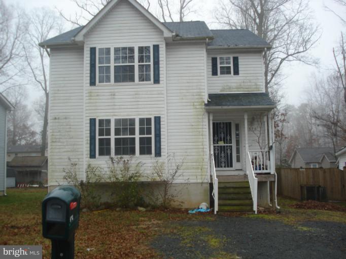 570 Balsom Road Lusby, MD 20657 - Photo 13 of 16 a front view of a house with garden