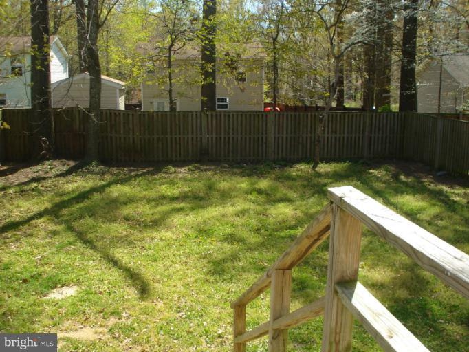 570 Balsom Road Lusby, MD 20657 - Photo 14 of 16 a yard with trees in the background