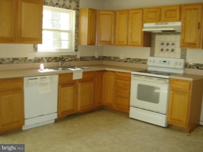 570 Balsom Road Lusby, MD 20657 - Photo 6 of 16 a kitchen with sink cabinets and window