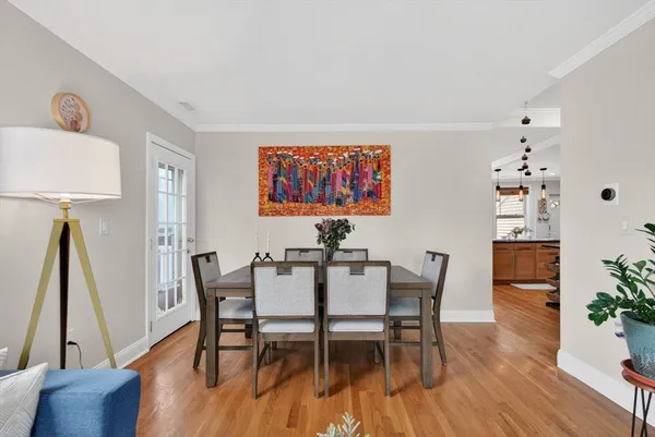 a view of a dining room with furniture and wooden floor