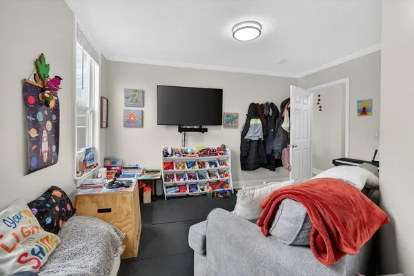a bedroom with bed and a flat screen tv